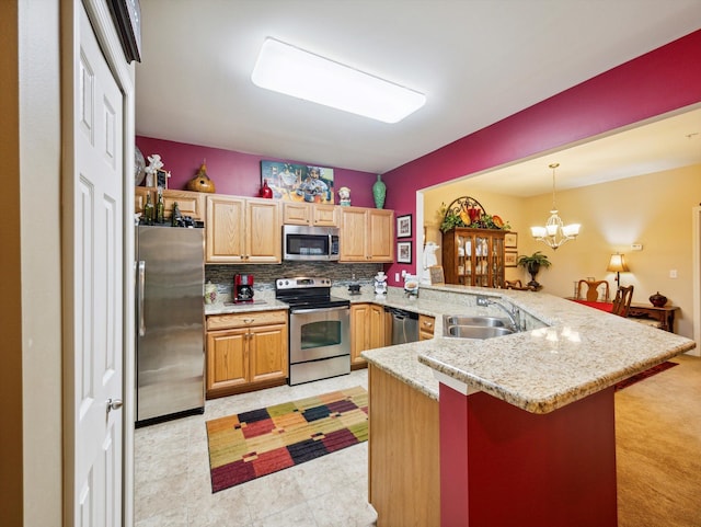 kitchen featuring kitchen peninsula, appliances with stainless steel finishes, sink, decorative light fixtures, and a notable chandelier