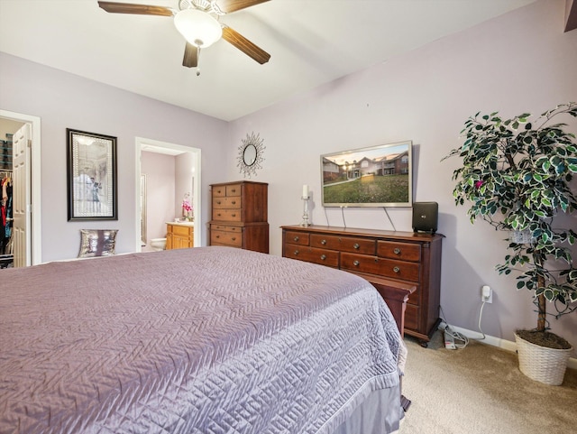 carpeted bedroom featuring connected bathroom, a closet, a spacious closet, and ceiling fan