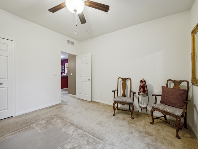 living area featuring ceiling fan and light carpet