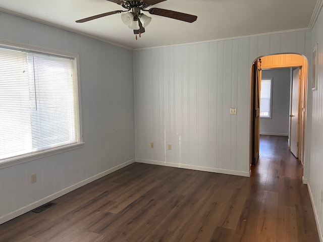 spare room featuring ceiling fan, dark hardwood / wood-style flooring, and ornamental molding