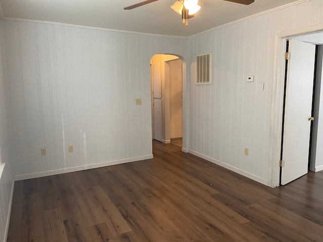 spare room with ceiling fan, dark hardwood / wood-style flooring, and ornamental molding