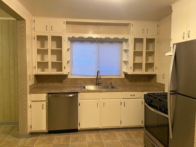 kitchen featuring stainless steel appliances, white cabinetry, and sink