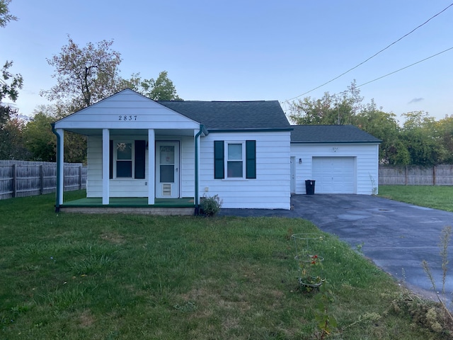 view of front facade with a front yard, a porch, and a garage