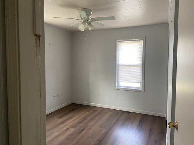 spare room featuring hardwood / wood-style floors, ceiling fan, and ornamental molding