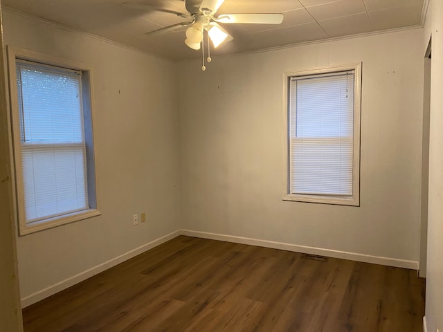 spare room featuring crown molding, dark hardwood / wood-style flooring, and ceiling fan