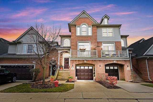 view of front of property featuring a balcony and a garage