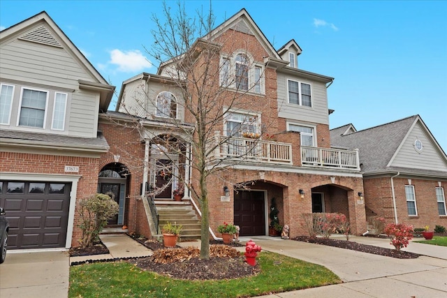 view of front of property featuring a balcony and a garage