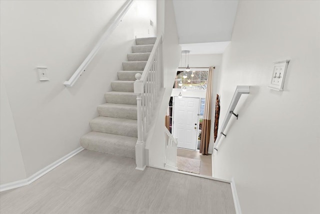 staircase with hardwood / wood-style floors