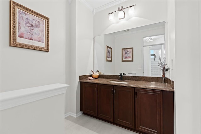 bathroom featuring crown molding and vanity