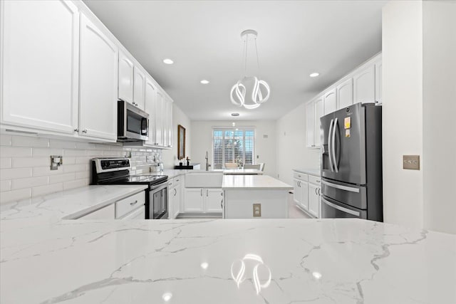 kitchen featuring white cabinetry, light stone countertops, sink, and appliances with stainless steel finishes