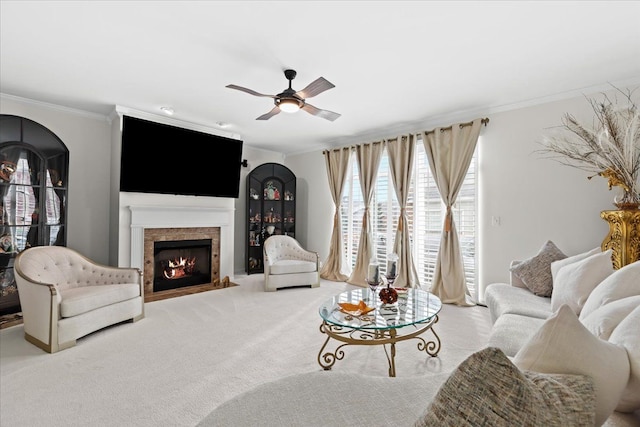 living room with ceiling fan, light colored carpet, and crown molding