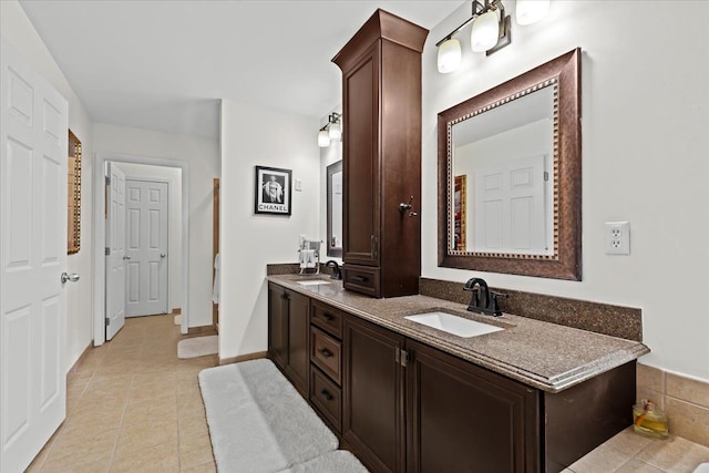 bathroom with tile patterned flooring and vanity