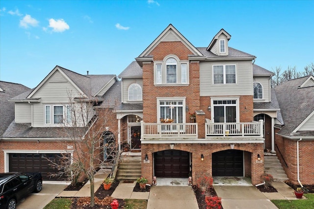 multi unit property featuring a balcony and a garage