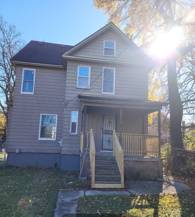 back of house featuring covered porch