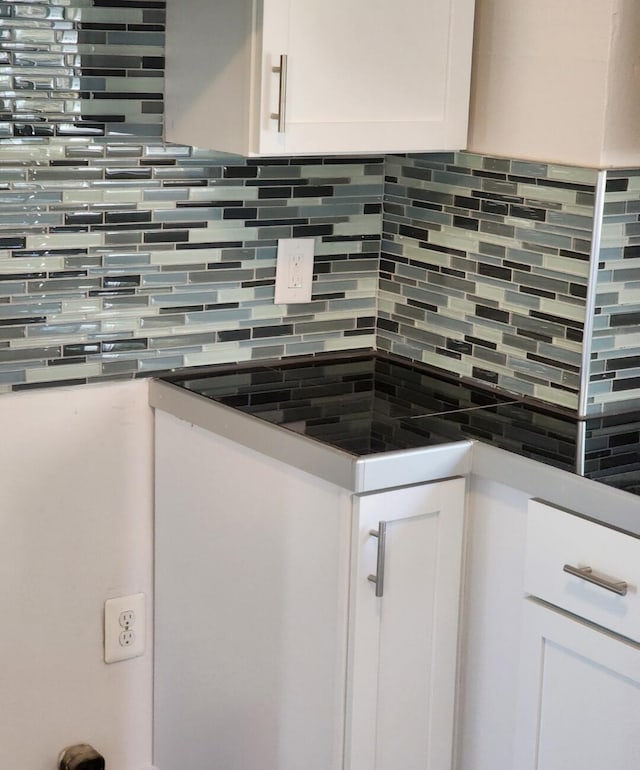 interior details with white cabinetry and tasteful backsplash