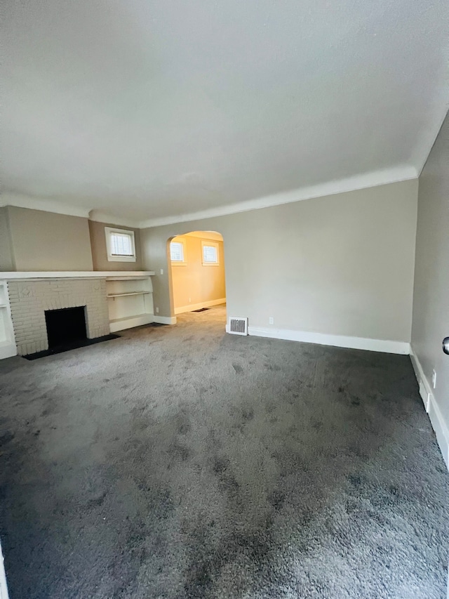 unfurnished living room featuring carpet and a fireplace