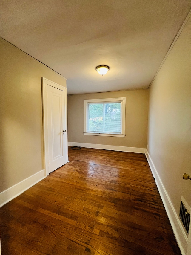 unfurnished room featuring dark hardwood / wood-style floors