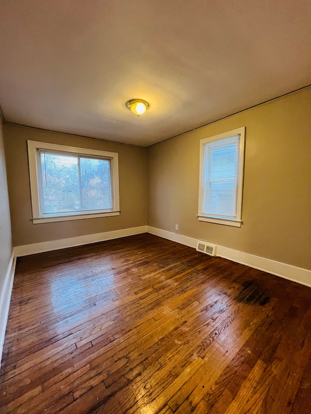 unfurnished room featuring dark hardwood / wood-style floors