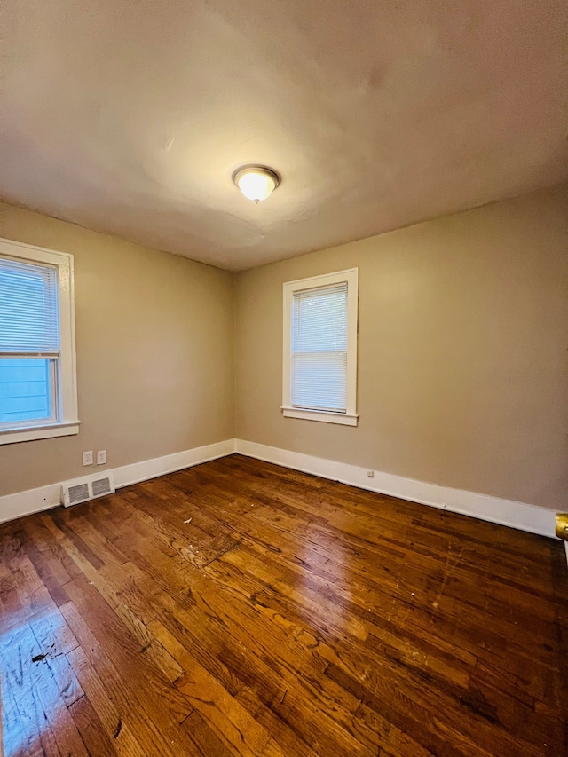 spare room with hardwood / wood-style floors and a wealth of natural light