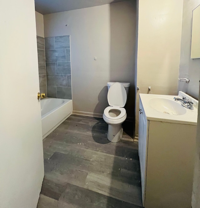 full bathroom with wood-type flooring, vanity, toilet, and tiled shower / bath