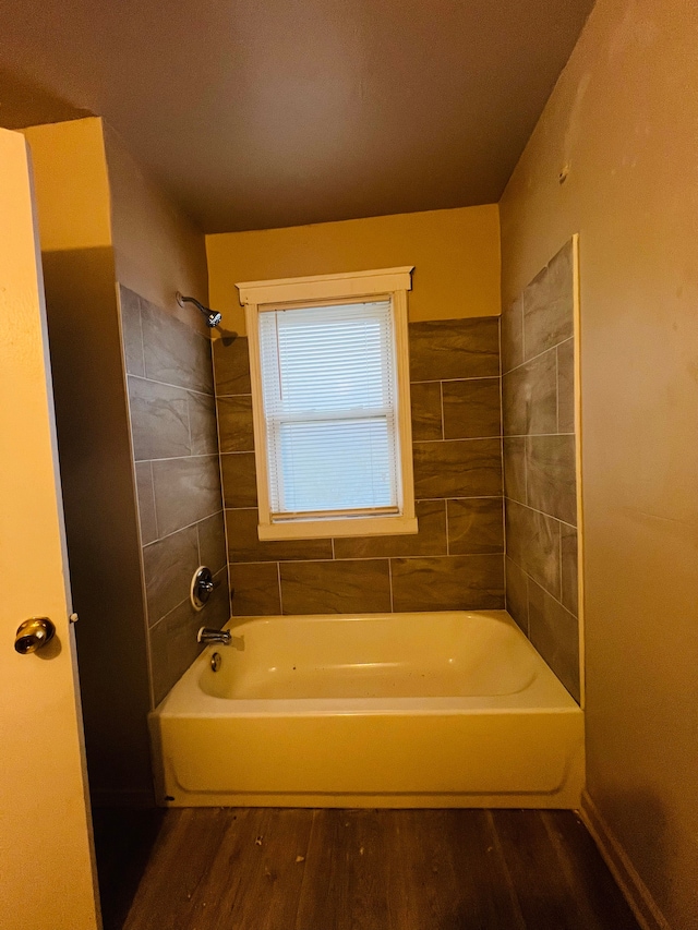 bathroom featuring tiled shower / bath and hardwood / wood-style flooring