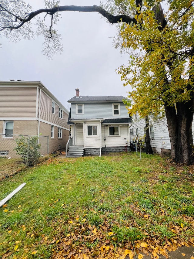 back of house featuring a yard