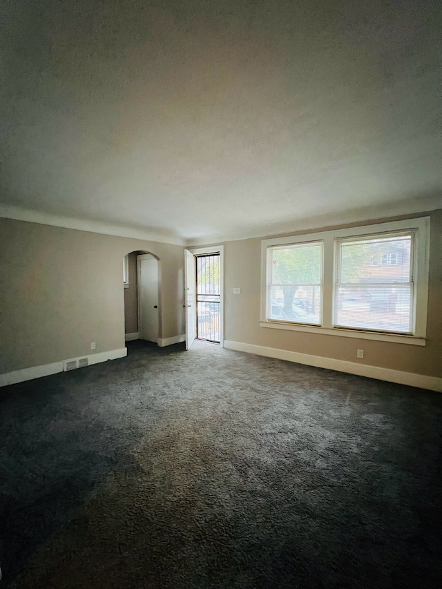 carpeted spare room featuring a textured ceiling