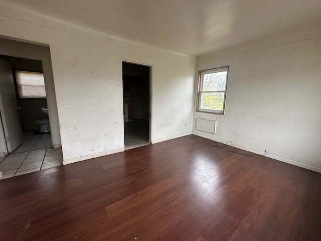 empty room with hardwood / wood-style flooring