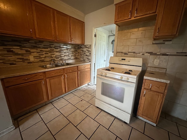 kitchen with backsplash, crown molding, white gas stove, and sink