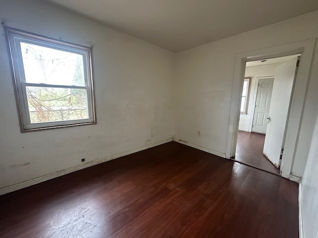 spare room featuring dark hardwood / wood-style flooring