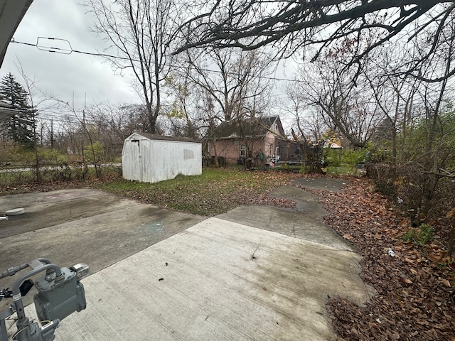 view of yard featuring a patio and a storage shed