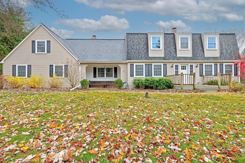 1320 Beth Ln, Ortonville, MI 48462 - view of front of property featuring a chimney, a shingled roof, and a front yard