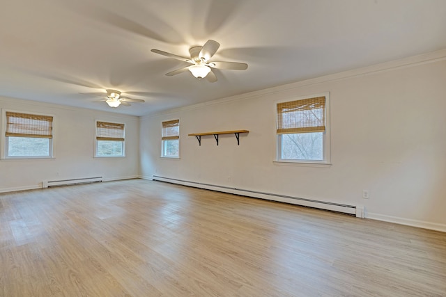 spare room with crown molding, light hardwood / wood-style flooring, ceiling fan, and a baseboard heating unit