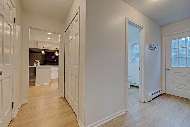 hallway featuring light hardwood / wood-style flooring and a baseboard heating unit