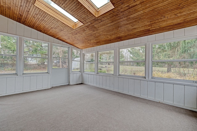 unfurnished sunroom featuring vaulted ceiling with skylight, wood ceiling, and a wealth of natural light