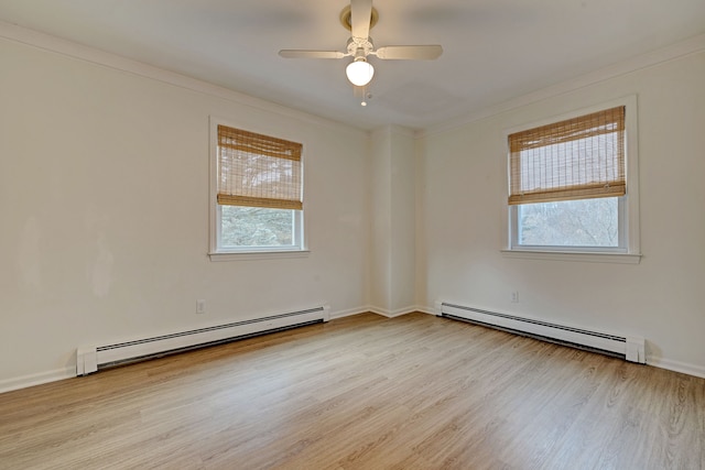 unfurnished room featuring light wood-type flooring, a baseboard radiator, and a healthy amount of sunlight