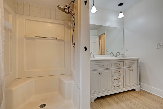 bathroom with a shower, vanity, and hardwood / wood-style flooring