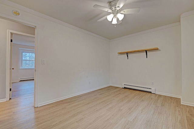 spare room featuring ceiling fan, light hardwood / wood-style floors, and baseboard heating