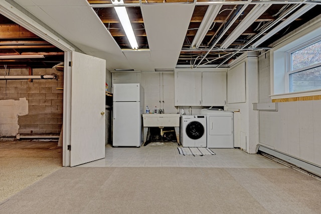 laundry area with cabinets, separate washer and dryer, and sink