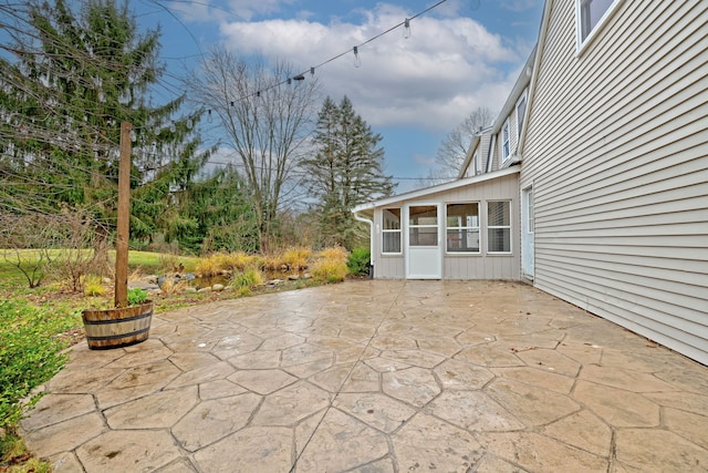 view of patio / terrace featuring a sunroom