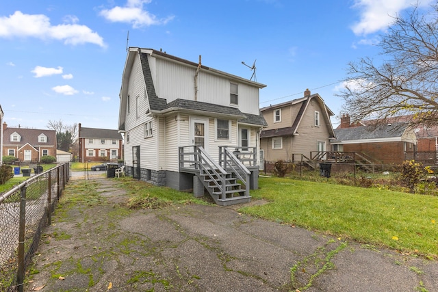 rear view of property with a yard