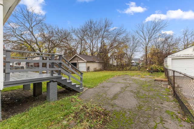 view of yard with an outdoor structure and a wooden deck