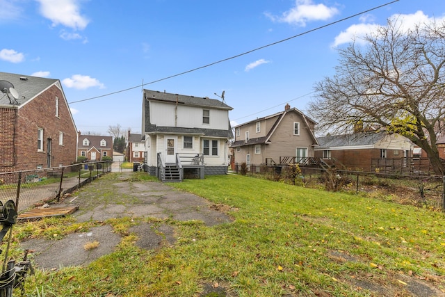 rear view of house with a yard