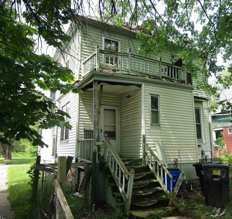 rear view of property with a balcony