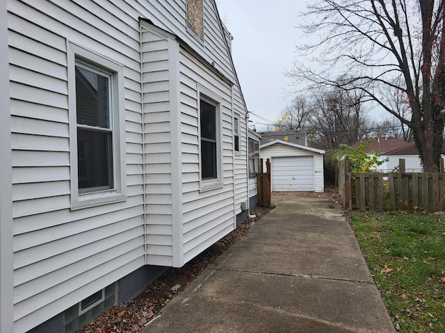 20501 Elkhart St, Harper Woods, MI 48225 - view of side of property with a detached garage, concrete driveway, and an outdoor structure