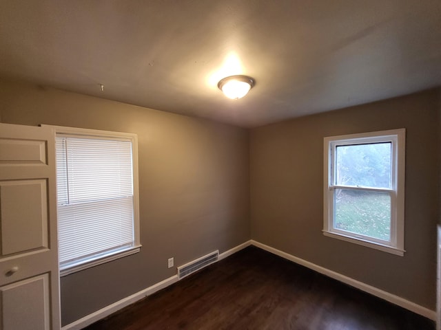 spare room featuring dark hardwood / wood-style floors