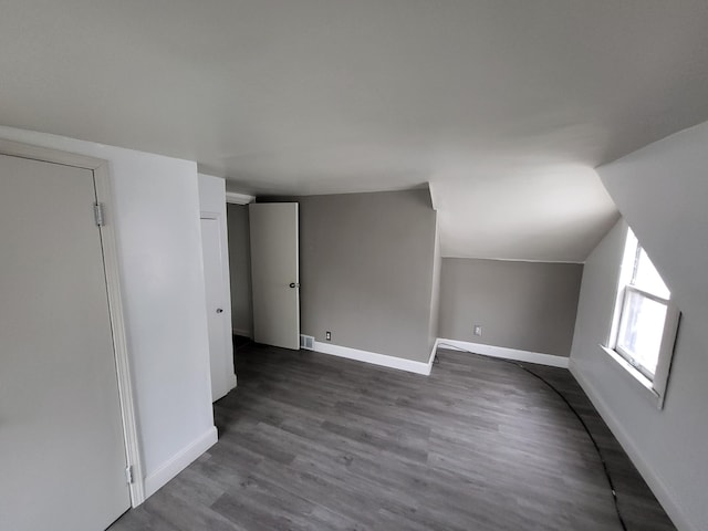 20501 Elkhart St, Harper Woods, MI 48225 - bonus room with baseboards, dark wood-type flooring, and lofted ceiling