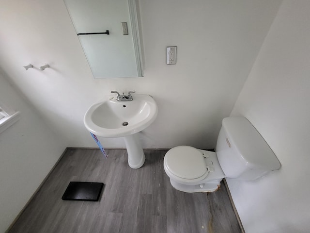 bathroom featuring hardwood / wood-style flooring and toilet