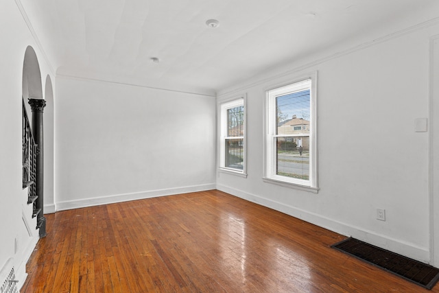 spare room featuring hardwood / wood-style flooring and crown molding