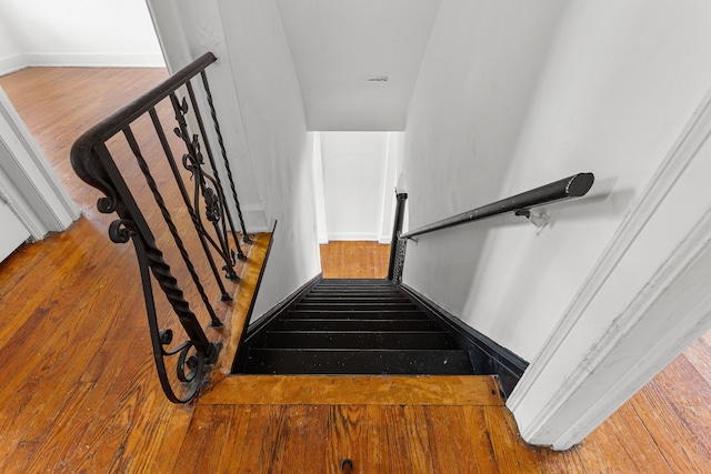 stairway featuring hardwood / wood-style flooring